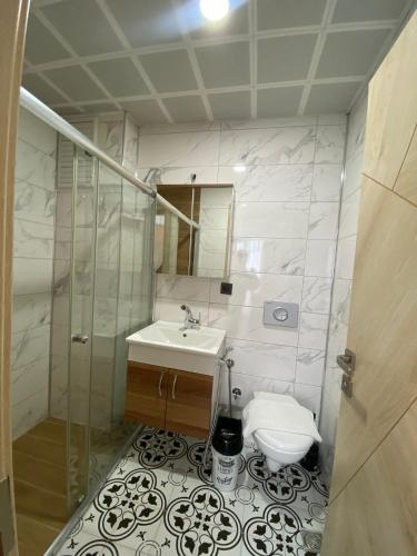 a bathroom with a sink and a toilet at Grand Bektas Suite in Trabzon