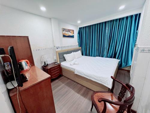 a small room with a bed and a television at Khách sạn Thy Thảo in Ho Chi Minh City