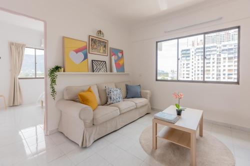 a living room with a couch and a table at Eastern Apt, Jelutong in Jelutong