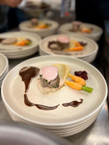a plate with a piece of food on a table at Hotel-Restaurant Steuermann in Karlsruhe