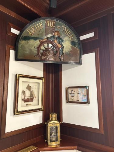 a sign for a ship on a wall with a clock at Hotel-Restaurant Steuermann in Karlsruhe