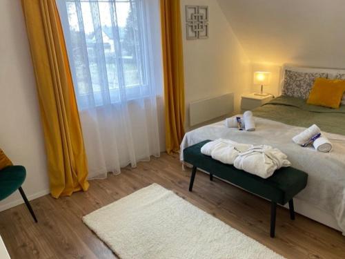 a bedroom with a bed with towels on it at Írisz Apartman teljes ház in Balatonmáriafürdő