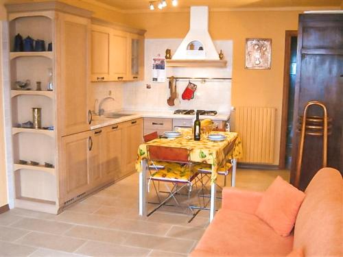 a kitchen with a table and a kitchen with a couch at Il Pergolato in Cannero Riviera