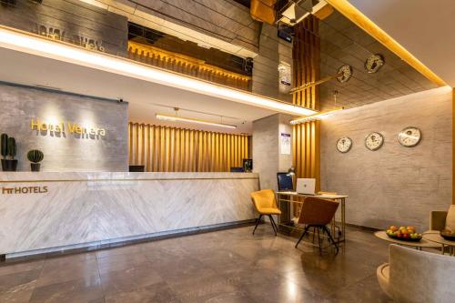 a lobby of a hotel with a reception desk and chairs at Hotel Venera Istanbul Old City in Istanbul