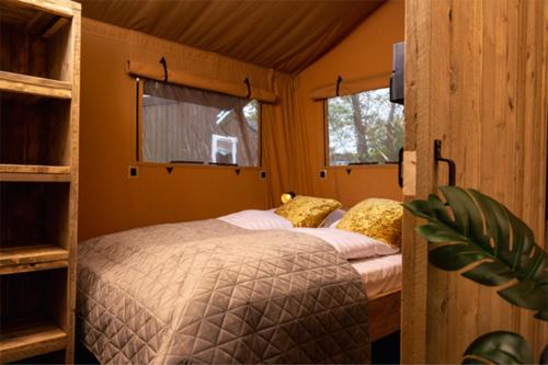 a bedroom with two beds in a room at Camping Le Val de Cesse in Mirepeisset