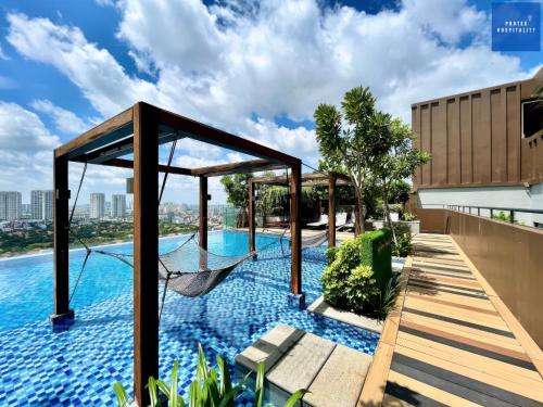a hammock on the roof of a house with a swimming pool at D'Edge Thao Dien - SkyPool Paradise in Ho Chi Minh City