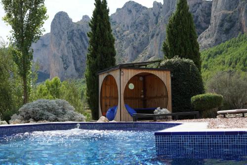 a house with a swimming pool with a gazebo at Torre de Arriba Casa Rural in Benimantell