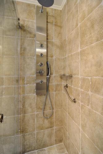 a bathroom with a shower with a shower head at Hotel Antique in Ioannina