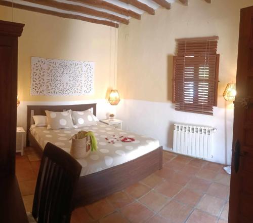 a bedroom with a large bed in a room at Torre de Arriba Casa Rural in Benimantell