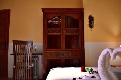 a bedroom with a large wooden hutch and a bed at Torre de Arriba Casa Rural in Benimantell