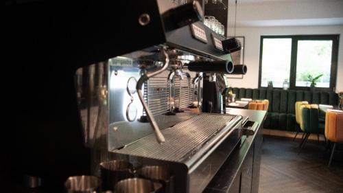 a kitchen with a coffee maker on a counter at Boutique Hotel GreenLeaf in Sinzing