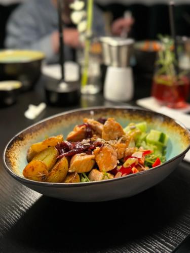 a bowl of food sitting on a table at Boutique Hotel GreenLeaf in Sinzing
