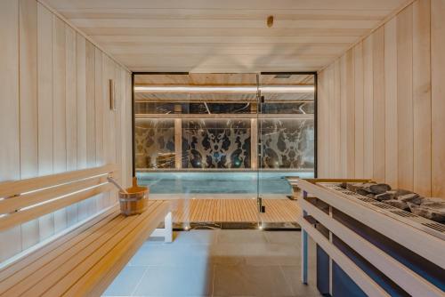 a swimming pool in a room with a glass door at Ultima Hotel Courchevel in Courchevel