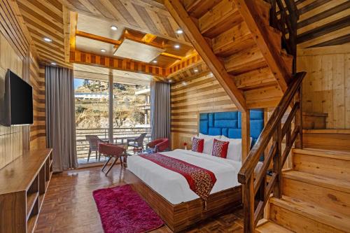 a bedroom with a large bed and a staircase at Sterling Shivalik Chail in Chail