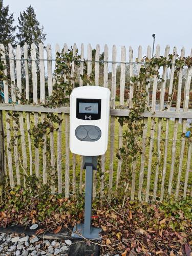 a pay meter in front of a fence at Château-ferme de Pondrome in Beauraing
