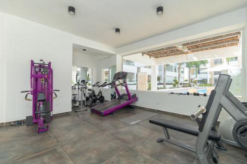 a gym with treadmills and exercise equipment in a room at Beautiful Apartment 10 min from Bayahibe beach Las Terrazas in Bayahibe