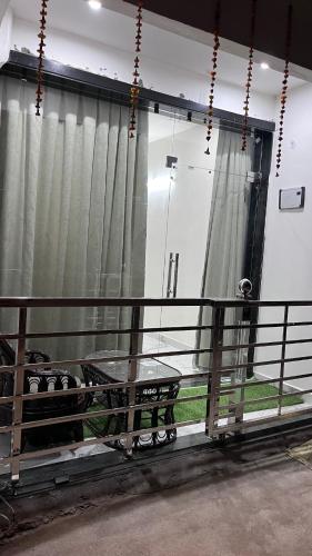 a balcony with a bench and a table and a window at Luxe 2 BHK Apartment in Orchha