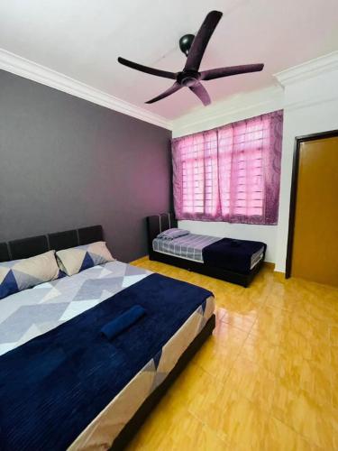 a bedroom with a bed and a ceiling fan at Bayan Homestay Bayan Lepas Penang in Bayan Lepas