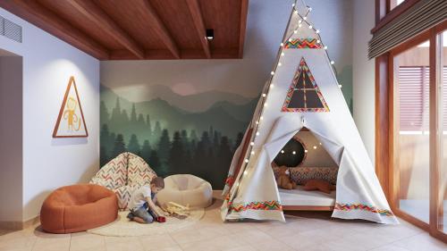 a childs room with a play tent and a bed at Paradisus by Meliá Bali in Nusa Dua
