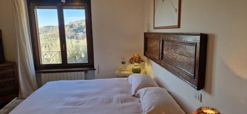 a bedroom with a large bed and a window at Alta Perugia B&B in Perugia