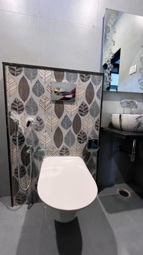 a bathroom with a white toilet and a sink at Luxe 2 BHK Apartment in Orchha
