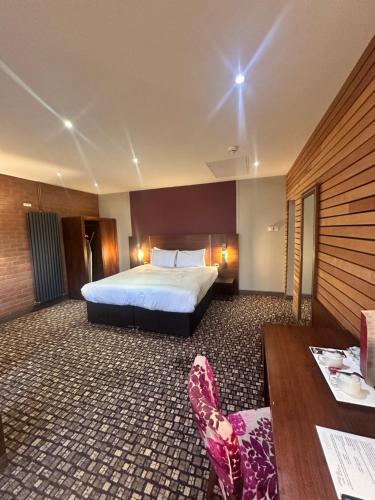 a hotel room with a bed and a desk at The Rutland Hotel in Sheffield