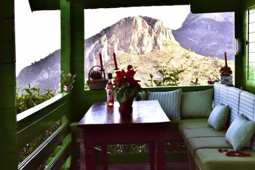 a room with a couch and a table with a mountain view at Torre de Arriba Casa Rural in Benimantell