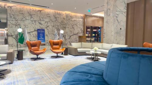 a lobby with couches and chairs in a store at Durrat Jalmouda Hotel in Al Jubail