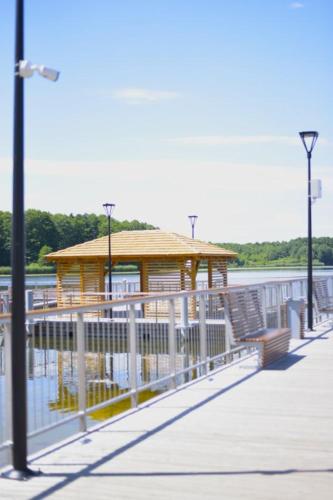 a gazebo on a pier next to the water at Gminny Ośrodek Sportów Wodnych w Białym Borze in Grudziądz