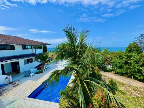 an aerial view of a house with a palm tree by a swimming pool at Long Beach Oceanview IL Villas Koh Lanta in Ko Lanta