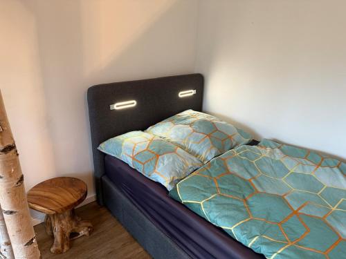 a bedroom with a bed with a blue comforter at Fantastische Hotel Alternative in Oststeinbek