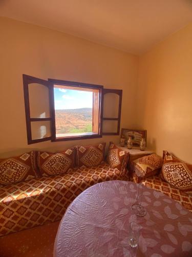 a living room with a couch and a window at Adoir N'salh in Tiznit