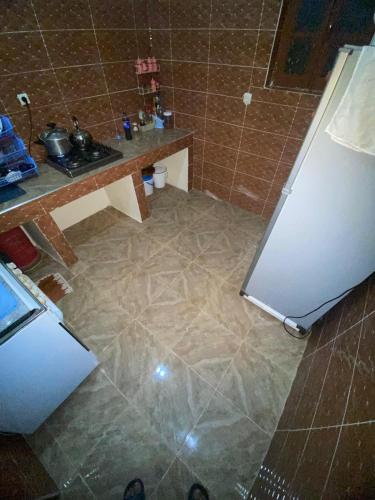 a kitchen with a counter and a refrigerator at Adoir N'salh in Tiznit