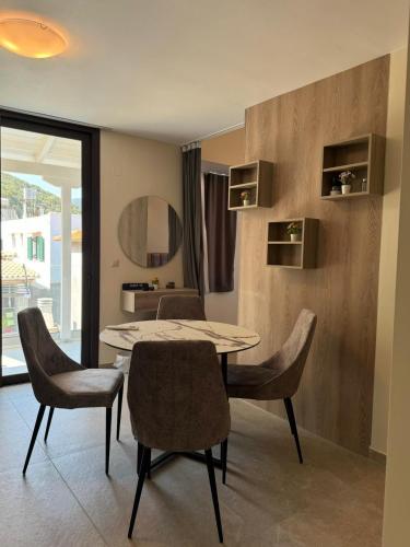 a dining room with a table and chairs at Zena Suites in Palaiokhóri