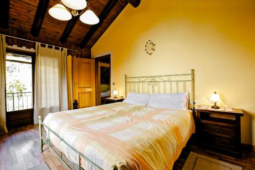 a bedroom with a large bed and a window at Rustico La Vigna in Cannero Riviera