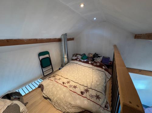 a bedroom with a bed in a room at Maison à l'orée du bois in Frangy