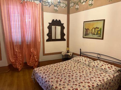 a bedroom with a bed and a mirror at Appartamento Giallo in Rio Marina