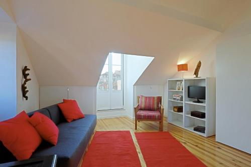 a living room with a blue couch and a red rug at Alfama 1 Terrace Lisboa Vida Boa in Lisbon