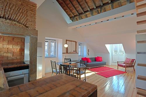 a kitchen and living room with a table and chairs at Alfama 1 Terrace Lisboa Vida Boa in Lisbon