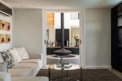 a living room with a couch and a table at Benguela Cove - Oceans Away in Hermanus