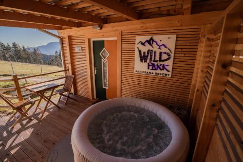 a large bath tub sitting outside of a building at Studio Wild Park Panorama with Hot tub and Sauna in Tolsti Vrh pri Ravnah naKoroškem