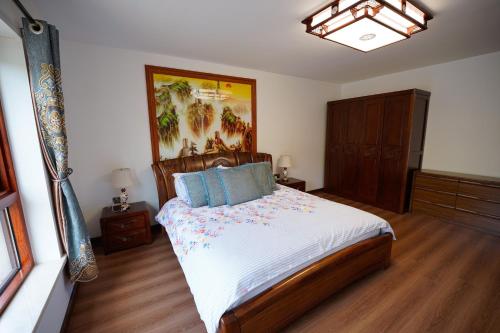 a bedroom with a bed and a painting on the wall at Tullynore Villa in Hillsborough