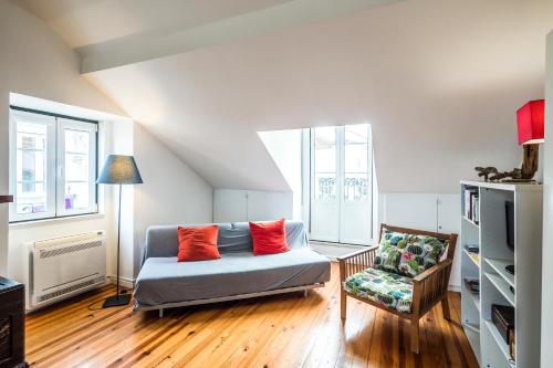 a living room with a couch and a chair at Alfama 1 Terrace Lisboa Vida Boa in Lisbon
