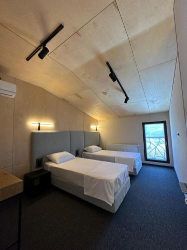 a room with two beds and a window at Camp Hotel Pura Vida in Tbilisi City