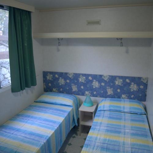 Ένα ή περισσότερα κρεβάτια σε δωμάτιο στο Villaggio La Giara