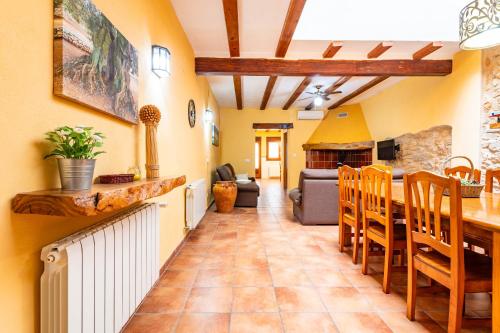 a kitchen and living room with a table and chairs at Les Oliveres Mil·lenaries 2 in La Jana
