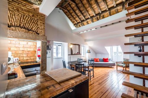 a kitchen and living room with a table and chairs at Alfama 1 Terrace Lisboa Vida Boa in Lisbon
