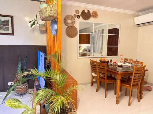 a dining room with a table and some plants at Entire House inside Residential Area, Banilad Cebu in Cebu City