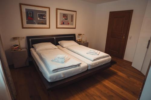 a bedroom with a bed with two towels on it at Thurners Dependance in Bruck an der Großglocknerstraße