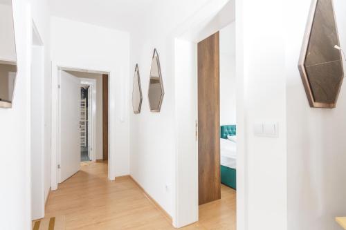 a hallway with white walls and wooden floors at pazaric residence in Doljani